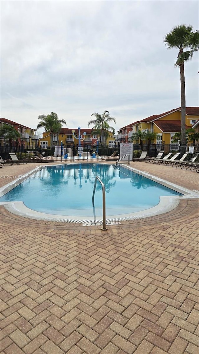 1013 Park Ridge Cir, Kissimmee, FL 34746 - community pool featuring a patio and fence