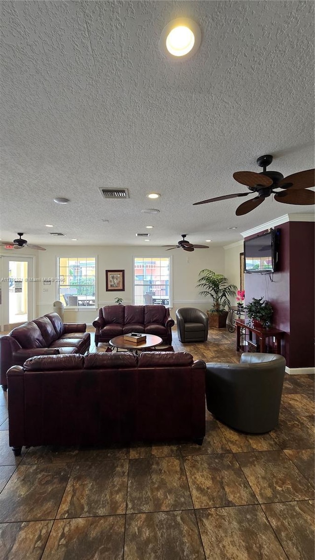 1013 Park Ridge Cir, Kissimmee, FL 34746 - living area featuring a ceiling fan, visible vents, and a textured ceiling