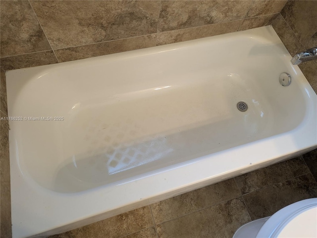 bathroom with a tub to relax in