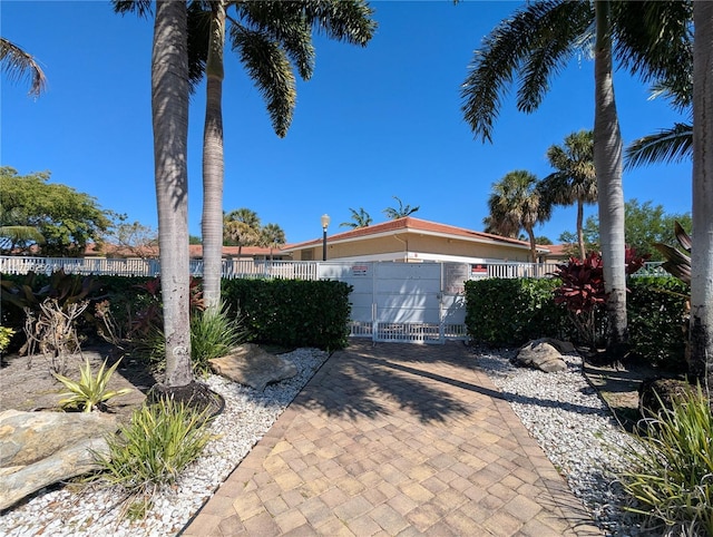 view of front of home with a fenced front yard and a gate