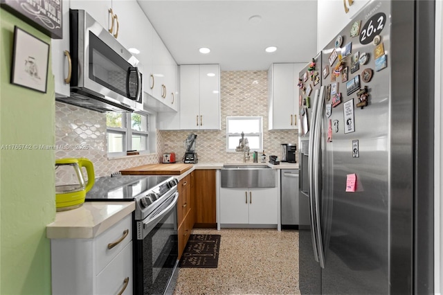 5233 NE 4th Ave, Oakland Park, FL 33334 - kitchen with light countertops, a sink, a wealth of natural light, and appliances with stainless steel finishes