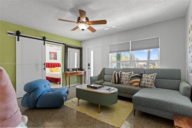 5233 NE 4th Ave, Oakland Park, FL 33334 - living room with a ceiling fan, speckled floor, a barn door, and a textured ceiling