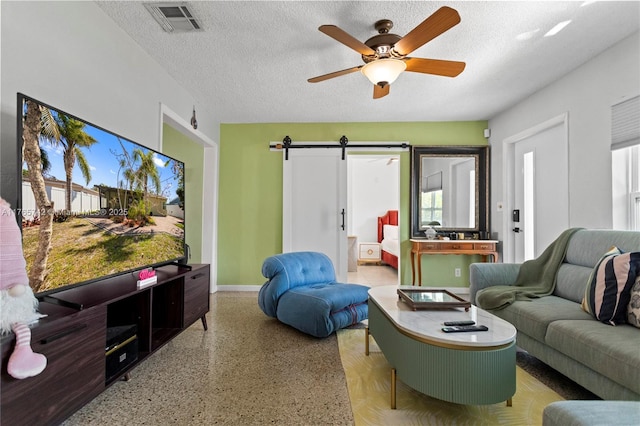 5233 NE 4th Ave, Oakland Park, FL 33334 - living area with speckled floor, a barn door, a textured ceiling, and visible vents