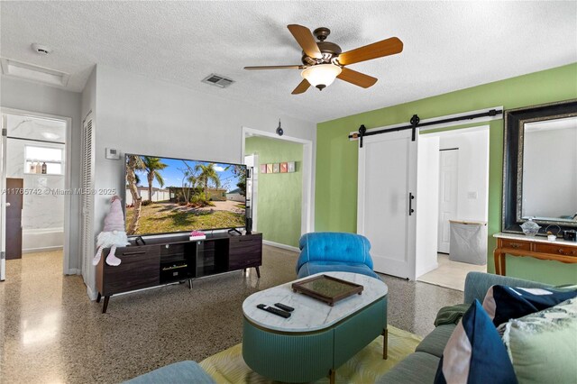 5233 NE 4th Ave, Oakland Park, FL 33334 - living room featuring visible vents, a textured ceiling, speckled floor, and ceiling fan