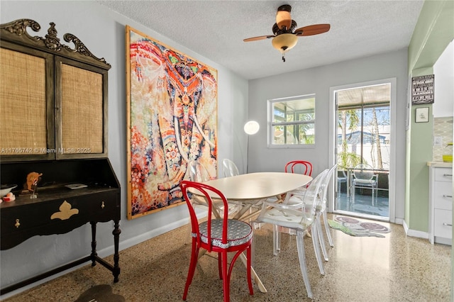 5233 NE 4th Ave, Oakland Park, FL 33334 - dining space featuring baseboards, a ceiling fan, speckled floor, and a textured ceiling