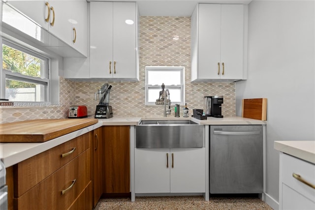 5233 NE 4th Ave, Oakland Park, FL 33334 - kitchen featuring light speckled floor, a sink, stainless steel dishwasher, and light countertops