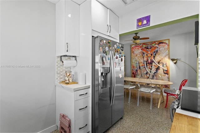 5233 NE 4th Ave, Oakland Park, FL 33334 - kitchen featuring light countertops, ceiling fan, white cabinetry, stainless steel refrigerator with ice dispenser, and light speckled floor
