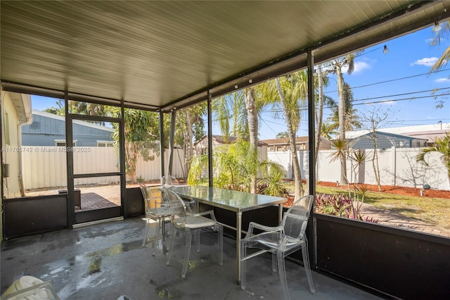 5233 NE 4th Ave, Oakland Park, FL 33334 - unfurnished sunroom featuring outdoor dining area