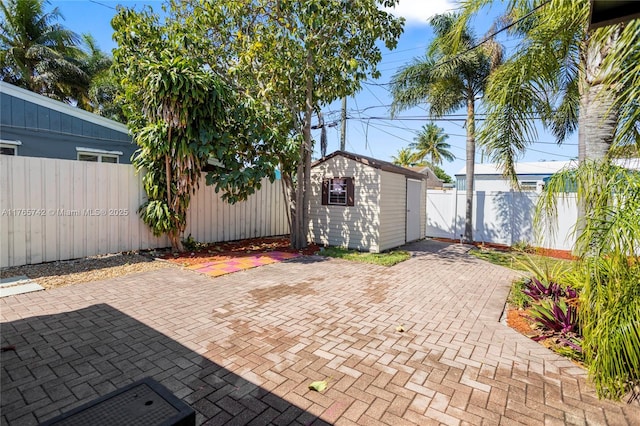 5233 NE 4th Ave, Oakland Park, FL 33334 - view of patio featuring a fenced backyard, an outbuilding, and a shed