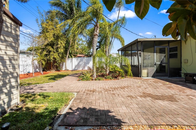 5233 NE 4th Ave, Oakland Park, FL 33334 - view of patio / terrace featuring a fenced backyard and a sunroom
