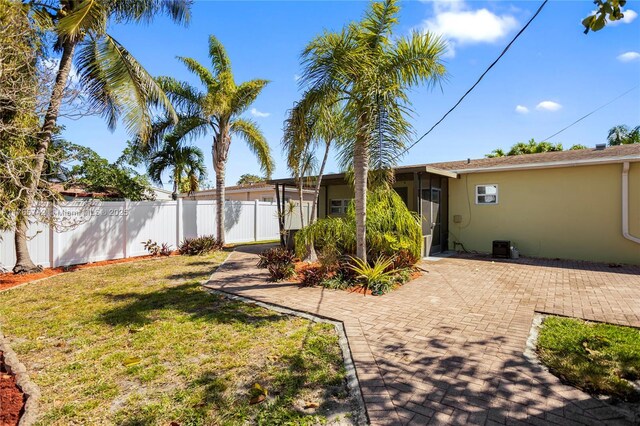 5233 NE 4th Ave, Oakland Park, FL 33334 - view of yard with fence and a patio