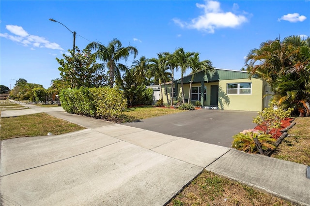 5233 NE 4th Ave, Oakland Park, FL 33334 - single story home with driveway and stucco siding