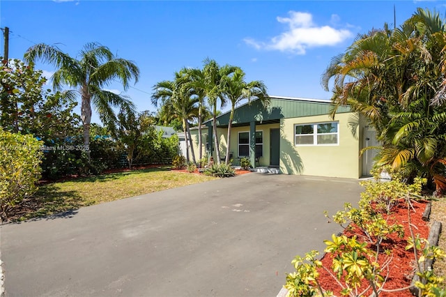 5233 NE 4th Ave, Oakland Park, FL 33334 - view of front of home featuring stucco siding and aphalt driveway