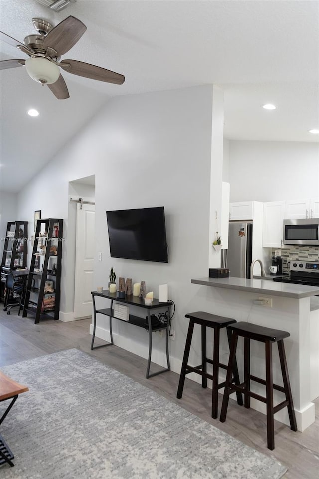 9203 NW 9th Ct, Plantation, FL 33324 - living area featuring high vaulted ceiling, a ceiling fan, light wood-type flooring, and baseboards