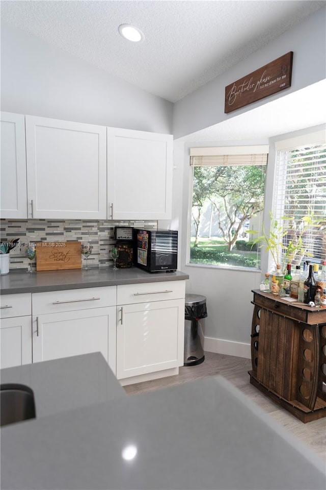 9203 NW 9th Ct, Plantation, FL 33324 - kitchen featuring tasteful backsplash, black microwave, and white cabinetry