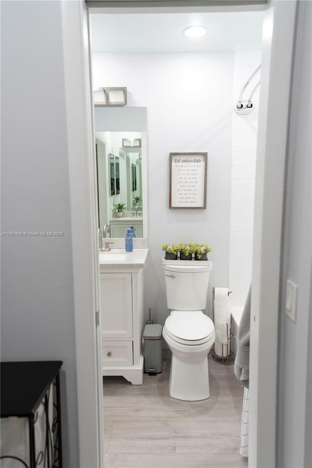 9203 NW 9th Ct, Plantation, FL 33324 - bathroom with vanity, toilet, wood finished floors, and tub / shower combination