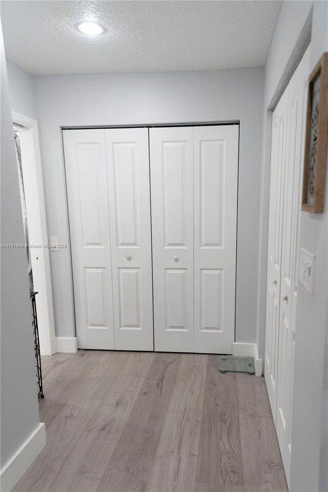 9203 NW 9th Ct, Plantation, FL 33324 - unfurnished bedroom featuring a closet, a textured ceiling, baseboards, and wood finished floors