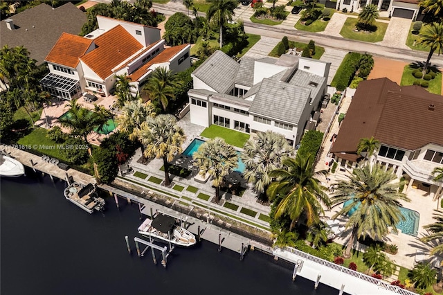 birds eye view of property with a water view and a residential view