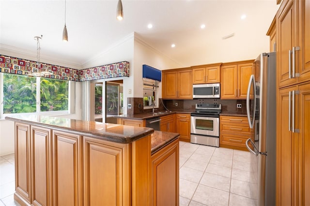 311 NW 197th Ave, Pembroke Pines, FL 33029 - kitchen with stainless steel appliances, vaulted ceiling, ornamental molding, light tile patterned floors, and decorative backsplash