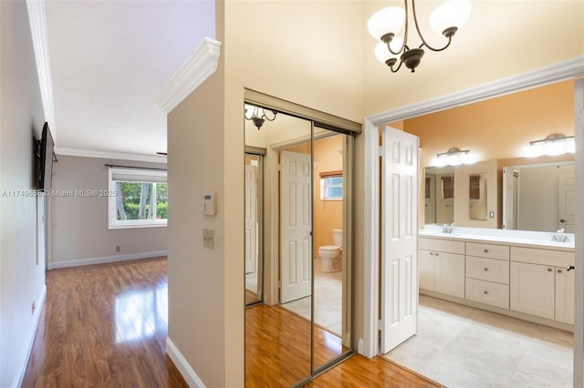 311 NW 197th Ave, Pembroke Pines, FL 33029 - interior space featuring double vanity, wood finished floors, toilet, and a notable chandelier