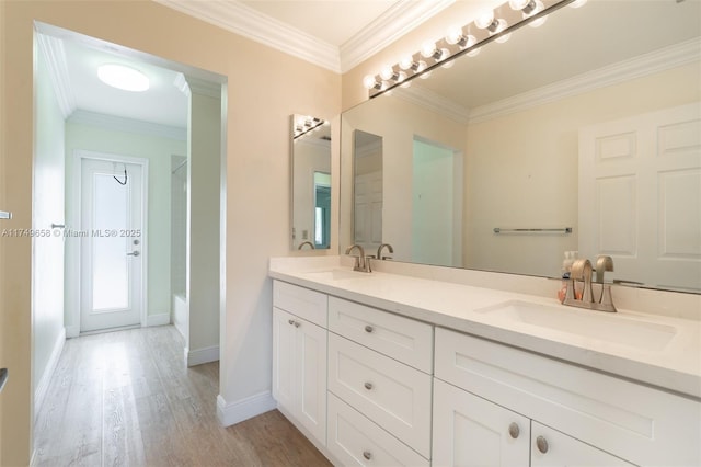311 NW 197th Ave, Pembroke Pines, FL 33029 - bathroom with wood finished floors, a sink, and ornamental molding