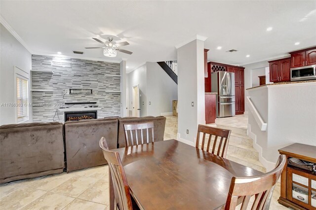 15852 SW 14th St, Pembroke Pines, FL 33027 - dining room with stairway, a ceiling fan, ornamental molding, a tiled fireplace, and recessed lighting