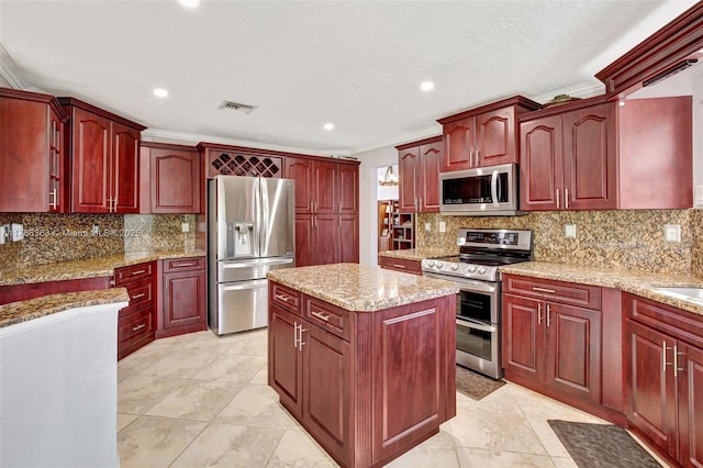 15852 SW 14th St, Pembroke Pines, FL 33027 - kitchen featuring stainless steel appliances, dark brown cabinets, a center island, recessed lighting, and ornamental molding