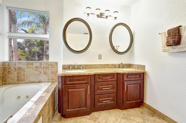 15852 SW 14th St, Pembroke Pines, FL 33027 - bathroom featuring a whirlpool tub, double vanity, and a textured wall