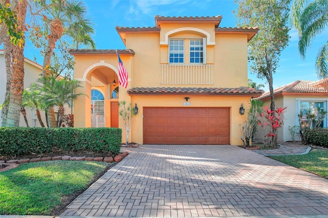 15852 SW 14th St, Pembroke Pines, FL 33027 - mediterranean / spanish-style home featuring a garage, stucco siding, decorative driveway, and a tile roof