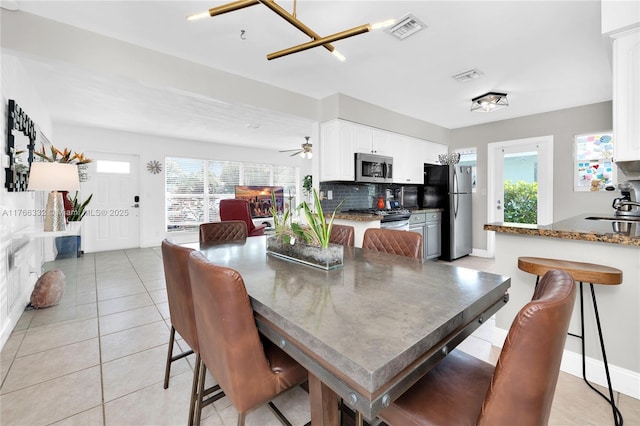 dining area with plenty of natural light, visible vents, and light tile patterned flooring
