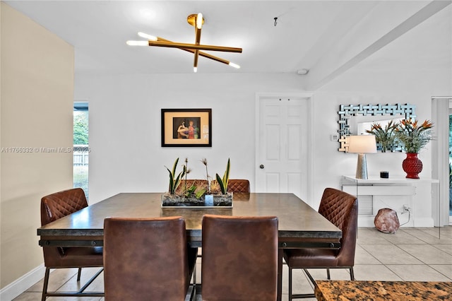 dining space featuring light tile patterned flooring and baseboards