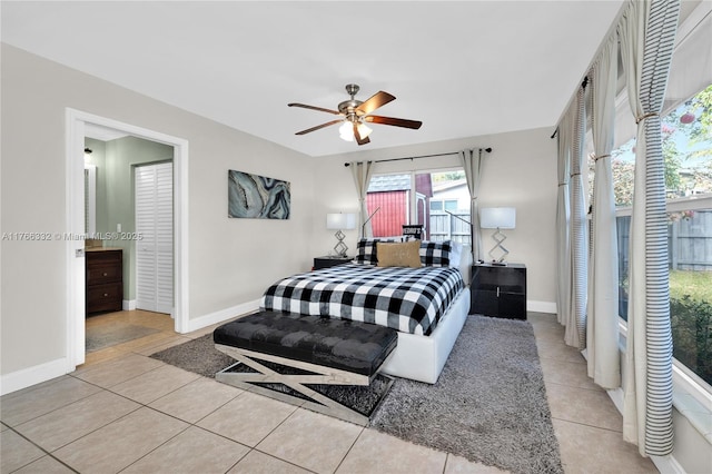 bedroom with tile patterned floors, baseboards, and a ceiling fan