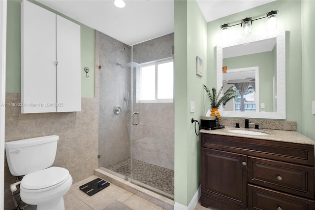 bathroom featuring a shower stall, a wealth of natural light, tile patterned flooring, and toilet