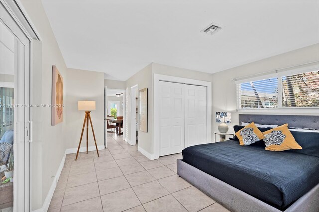 3449 NE 17th Way, Oakland Park, FL 33334 - bedroom with light tile patterned floors, a closet, and baseboards