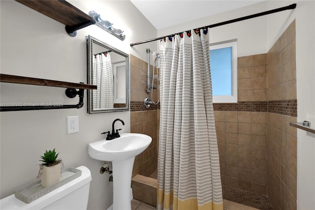 bathroom with toilet and a shower stall