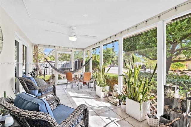 sunroom / solarium with a ceiling fan
