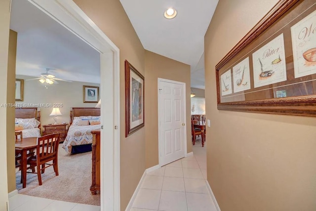 corridor featuring light tile patterned flooring, recessed lighting, and baseboards