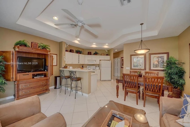 8910 Sandshot Ct Unit 5123, Port St Lucie, FL 34986 - living area with a tray ceiling, ceiling fan, recessed lighting, light tile patterned floors, and baseboards