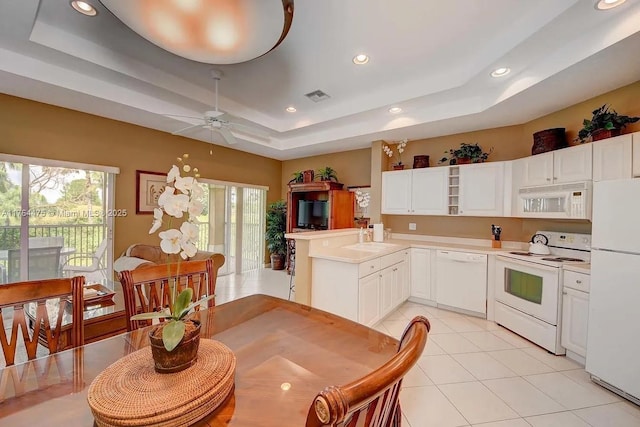 8910 Sandshot Ct Unit 5123, Port St Lucie, FL 34986 - kitchen featuring white appliances, a tray ceiling, a ceiling fan, light countertops, and light tile patterned flooring