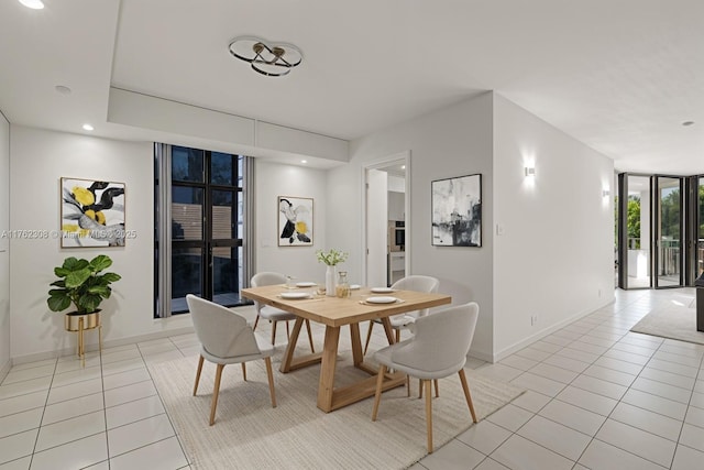 4000 Towerside Ter Unit 302, Miami, FL 33138 - dining area with light tile patterned floors, floor to ceiling windows, baseboards, and recessed lighting