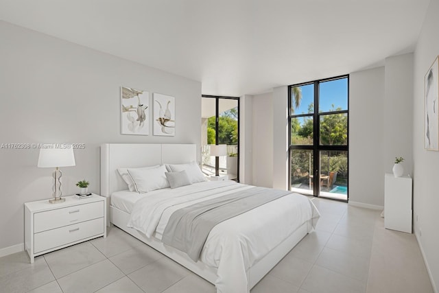 4000 Towerside Ter Unit 302, Miami, FL 33138 - bedroom with light tile patterned flooring, baseboards, and a wall of windows