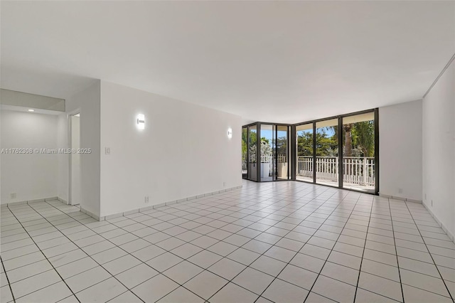 4000 Towerside Ter Unit 302, Miami, FL 33138 - spare room with a wall of windows and light tile patterned flooring