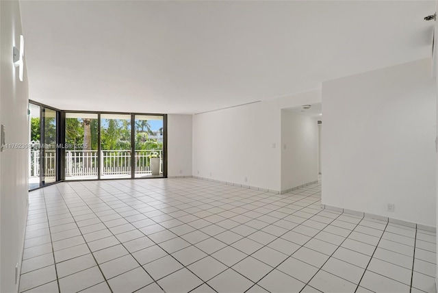 4000 Towerside Ter Unit 302, Miami, FL 33138 - empty room with a wall of windows and light tile patterned floors