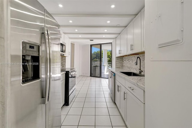4000 Towerside Ter Unit 302, Miami, FL 33138 - kitchen featuring appliances with stainless steel finishes, a sink, backsplash, light tile patterned floors, and recessed lighting