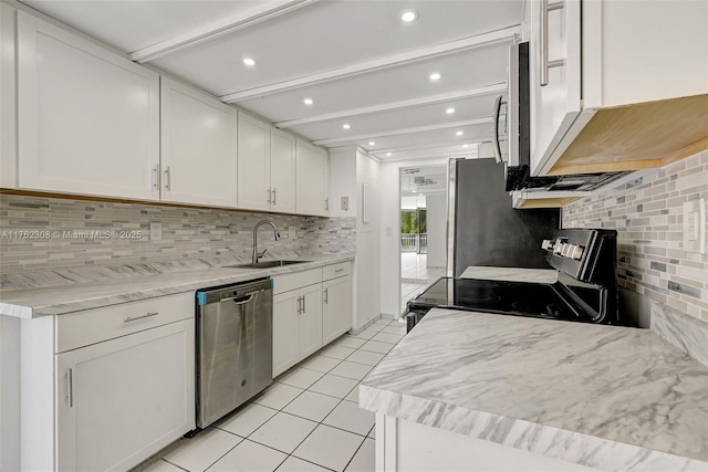4000 Towerside Ter Unit 302, Miami, FL 33138 - kitchen with appliances with stainless steel finishes, a sink, light tile patterned flooring, backsplash, and white cabinets
