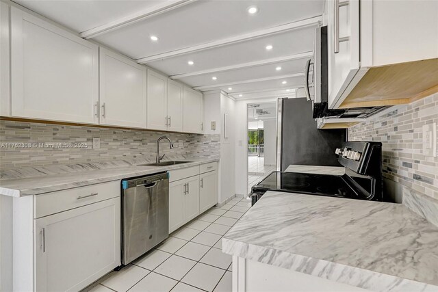 4000 Towerside Ter Unit 302, Miami, FL 33138 - kitchen featuring stainless steel appliances, a sink, light tile patterned floors, backsplash, and recessed lighting