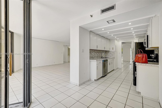 4000 Towerside Ter Unit 302, Miami, FL 33138 - kitchen with a sink, tasteful backsplash, light countertops, appliances with stainless steel finishes, and white cabinets