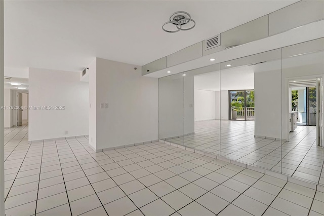 4000 Towerside Ter Unit 302, Miami, FL 33138 - empty room featuring light tile patterned flooring, recessed lighting, and baseboards