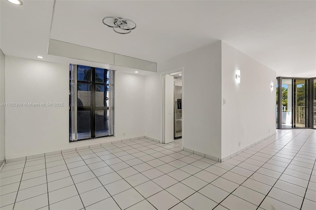 4000 Towerside Ter Unit 302, Miami, FL 33138 - unfurnished room with light tile patterned floors, baseboards, recessed lighting, and expansive windows