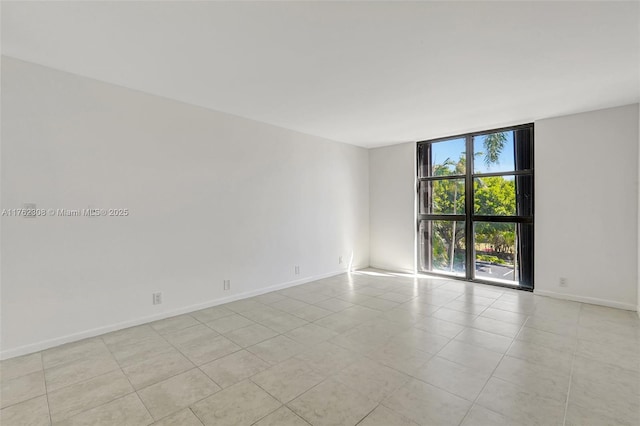 4000 Towerside Ter Unit 302, Miami, FL 33138 - unfurnished room with expansive windows, light tile patterned flooring, and baseboards